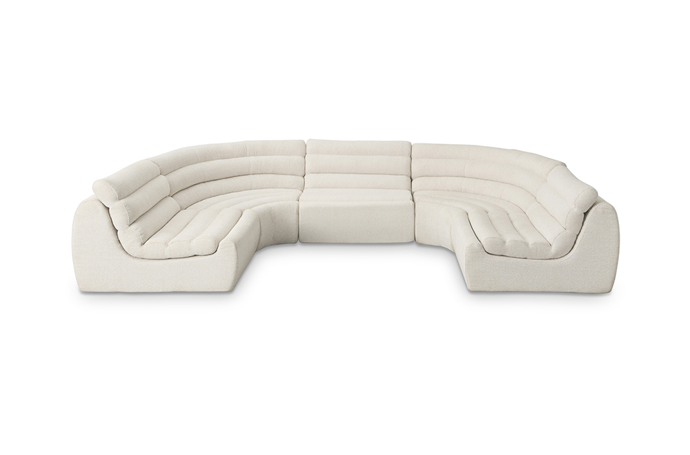 Beige high back modular sofa in a large U shape configuration with rounded arms and channelled seat cushions.