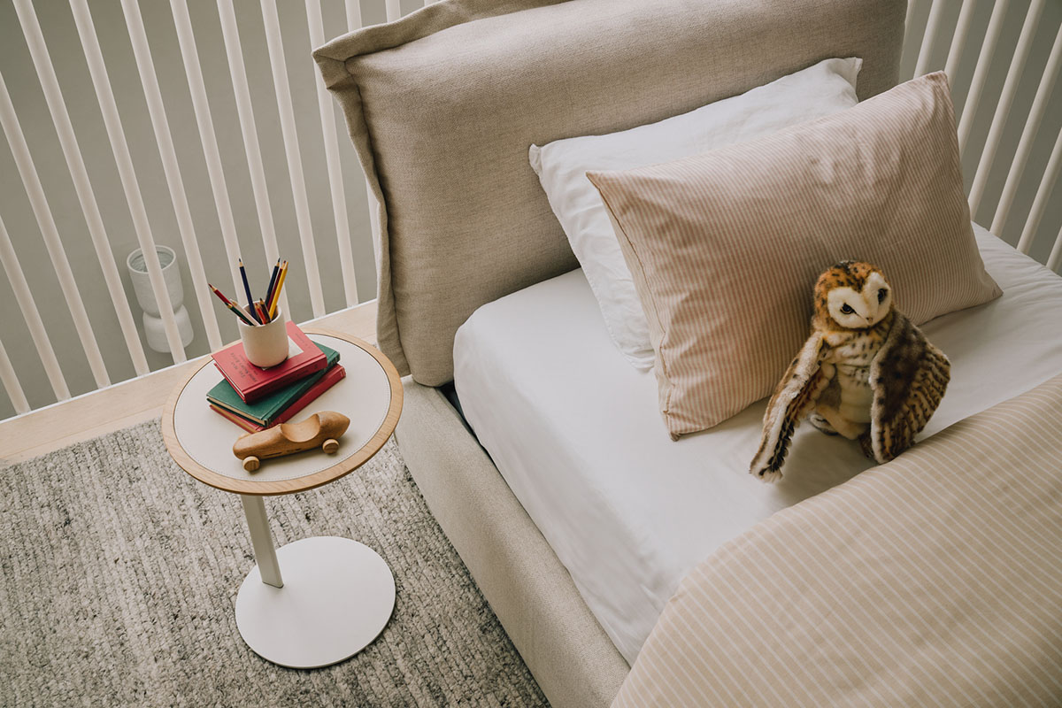 A spotlight on the Delta Coast Bed’s plush and padded bedhead, styled with children’s décor and toys.