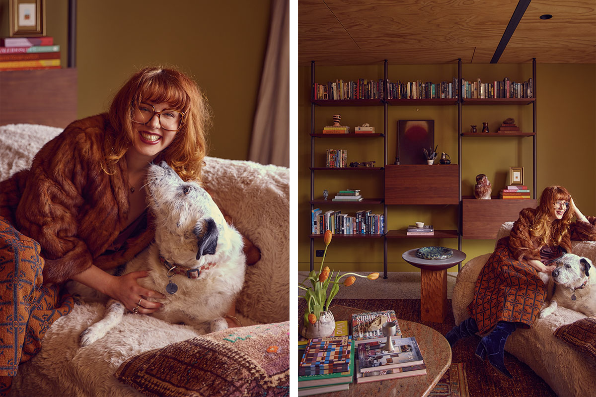 Ruby and her dog smile sat on the sheepskin-style sofa in her cosy living room with a warm colour palette.